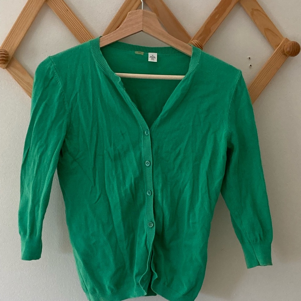 Short, green cardigan sweater with 3/4 length sleeves.